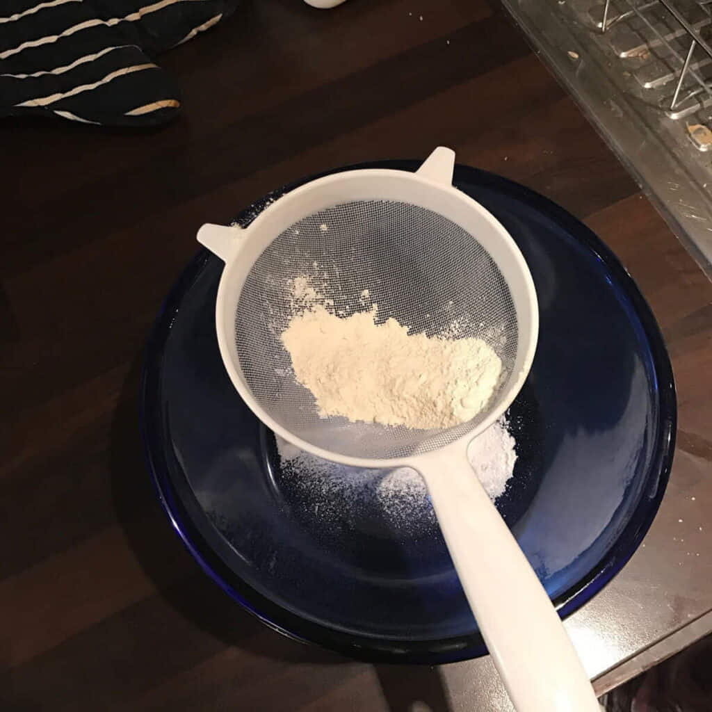Sifting the flour for Baking Mince Pies